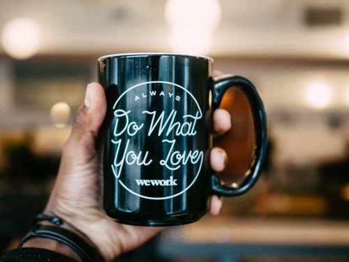 A mug with WeWork's slogan 'do what you love' on it